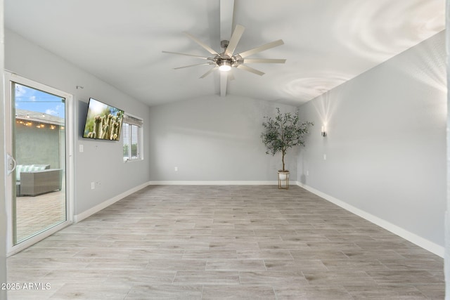 unfurnished room with a ceiling fan, vaulted ceiling, baseboards, and light wood finished floors
