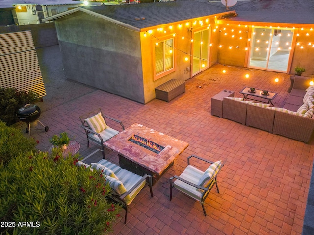 view of patio / terrace with an outdoor living space with a fire pit