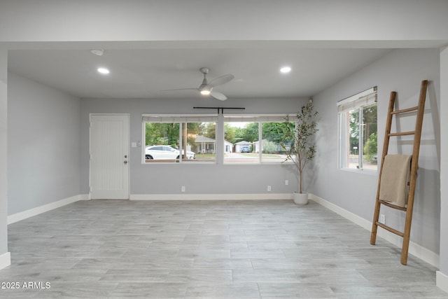spare room featuring ceiling fan, recessed lighting, baseboards, and light wood finished floors