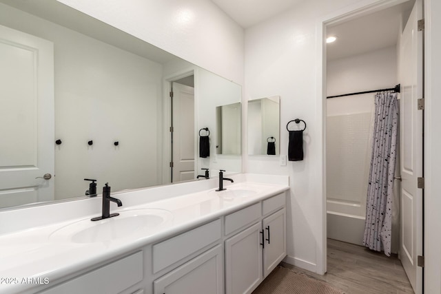 5460 S Dillon Cir, Mesa, AZ 85212 - bathroom with double vanity, wood finished floors, shower / tub combo with curtain, and baseboards