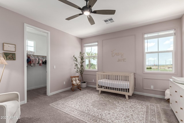 5460 S Dillon Cir, Mesa, AZ 85212 - carpeted bedroom with a spacious closet, baseboards, ceiling fan, a crib, and a closet