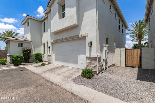 5460 S Dillon Cir, Mesa, AZ 85212 - view of front facade with stucco siding, a gate, a garage, and driveway