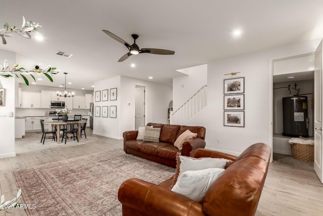 5460 S Dillon Cir, Mesa, AZ 85212 - living area with electric water heater, stairway, a ceiling fan, light wood-style floors, and a chandelier