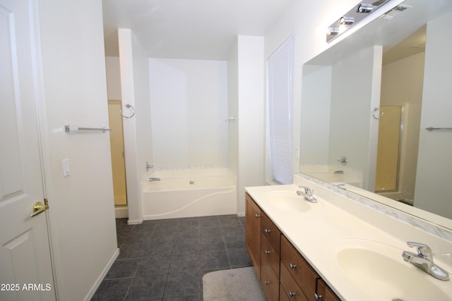 bathroom with a garden tub, a sink, and double vanity