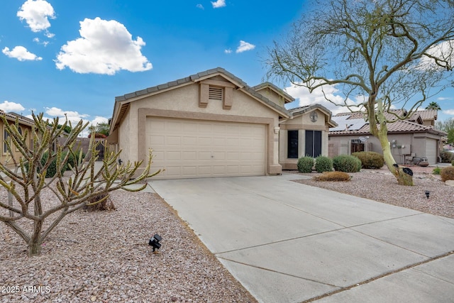 view of front of property featuring a tile roof, driveway, an attached garage, and stucco siding