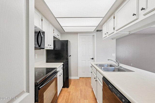 2815 N 52nd St Unit 3, Phoenix, AZ 85008 - kitchen with black appliances, light wood finished floors, white cabinets, and light countertops