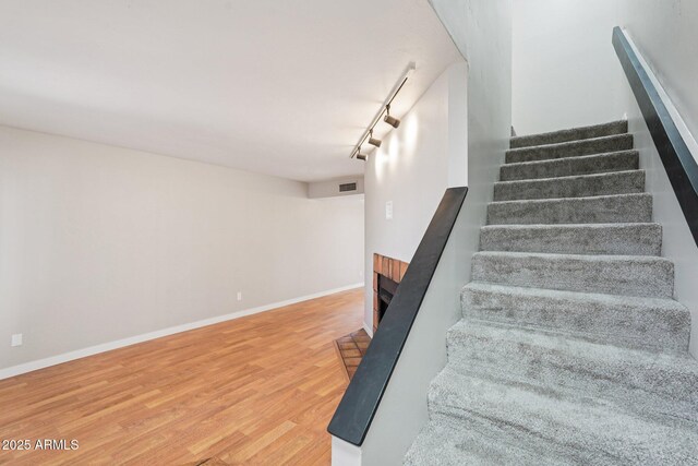 2815 N 52nd St Unit 3, Phoenix, AZ 85008 - stairs with rail lighting, wood finished floors, and a fireplace