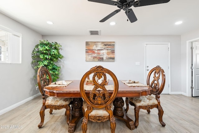 dining room with visible vents, baseboards, and light wood finished floors