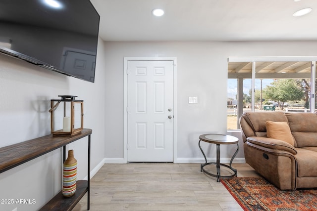 foyer featuring recessed lighting, baseboards, and light wood finished floors