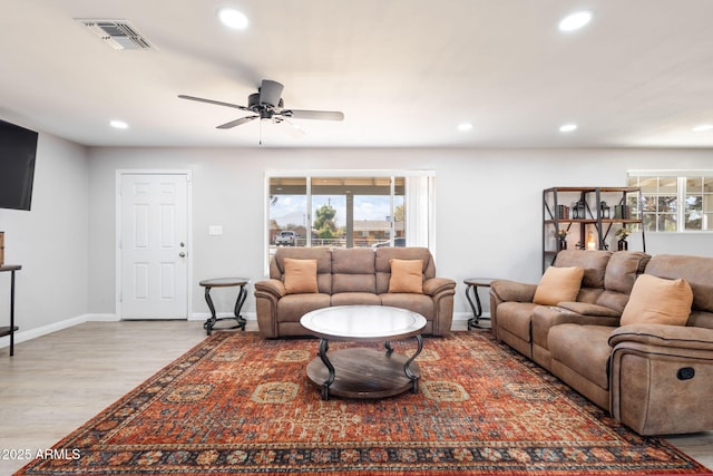 living room featuring recessed lighting, visible vents, baseboards, and wood finished floors