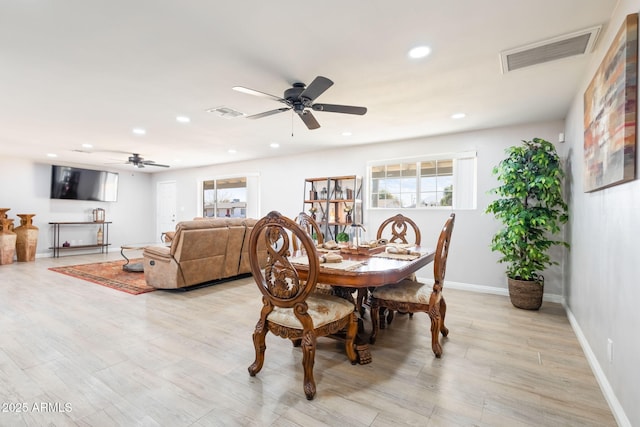 dining room featuring light wood-style floors, visible vents, and a wealth of natural light