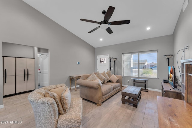 living room with light hardwood / wood-style floors, high vaulted ceiling, and ceiling fan