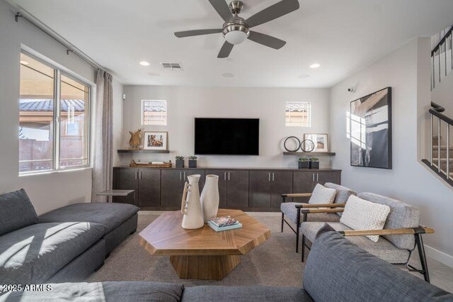 12233 W Caraveo Pl, Peoria, AZ 85383 - living room with healthy amount of natural light, carpet flooring, ceiling fan, recessed lighting, and stairs