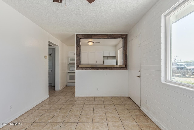 3128 W Pima St Unit 2, Phoenix, AZ 85009 - empty room with a textured ceiling, ceiling fan, and light tile patterned floors