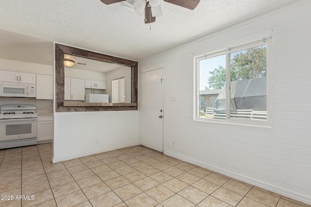 3128 W Pima St Unit 2, Phoenix, AZ 85009 - kitchen with white appliances, a ceiling fan, white cabinetry, a textured ceiling, and light tile patterned flooring