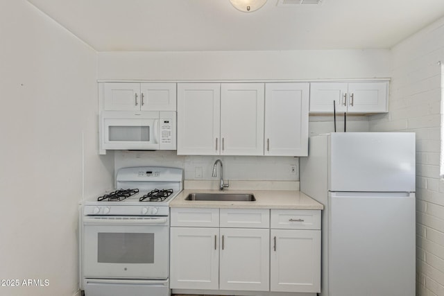 3128 W Pima St Unit 2, Phoenix, AZ 85009 - kitchen featuring white appliances, light countertops, and white cabinetry