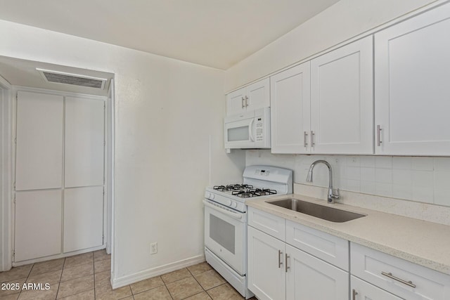 3128 W Pima St Unit 2, Phoenix, AZ 85009 - kitchen featuring white appliances, white cabinets, and light tile patterned flooring
