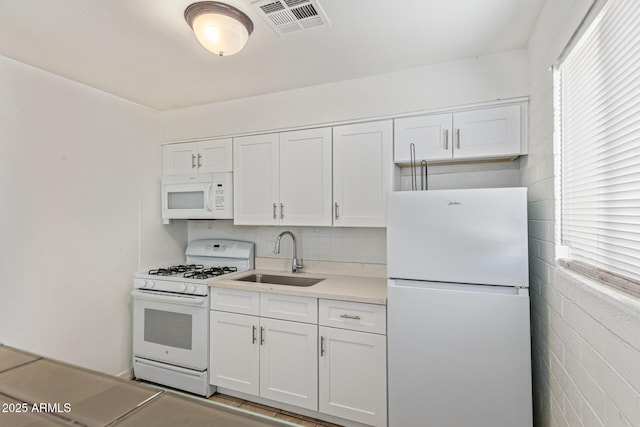 3128 W Pima St Unit 2, Phoenix, AZ 85009 - kitchen featuring white appliances, white cabinetry, light countertops, and tasteful backsplash