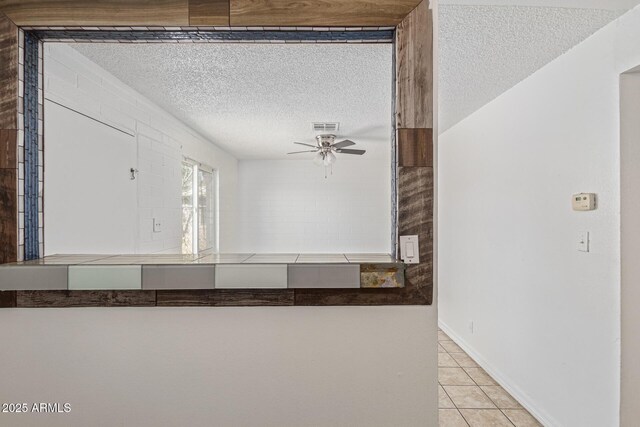 3128 W Pima St Unit 2, Phoenix, AZ 85009 - tiled empty room featuring a textured ceiling and a ceiling fan
