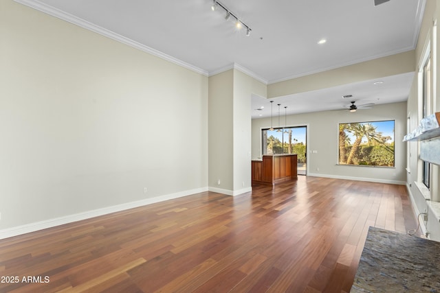 unfurnished living room with hardwood / wood-style floors, crown molding, track lighting, and ceiling fan