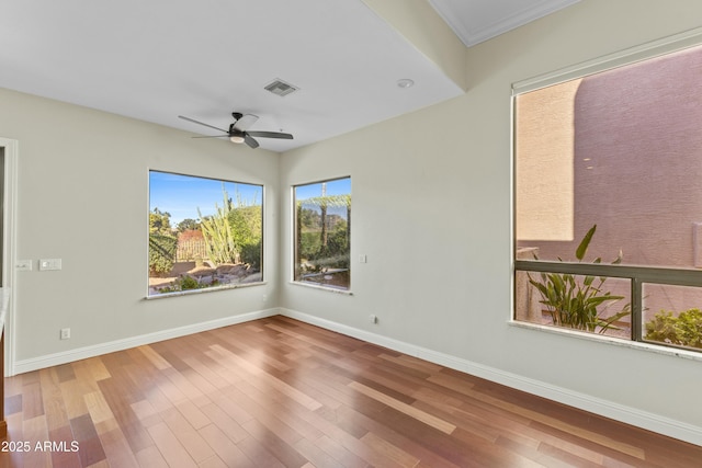 spare room with hardwood / wood-style flooring and ceiling fan