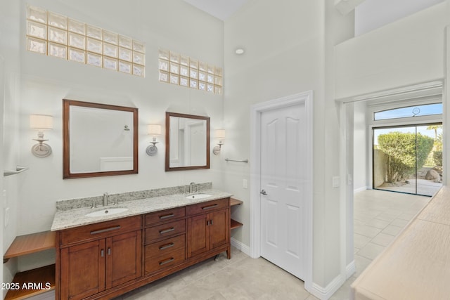 bathroom featuring a high ceiling, vanity, and tile patterned flooring