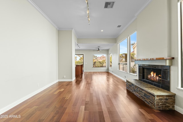 unfurnished living room with crown molding, hardwood / wood-style flooring, rail lighting, and ceiling fan