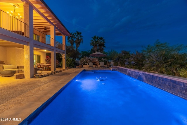 15857 E Ponderosa Dr, Fountain Hills, AZ 85268 - pool at night featuring a patio area, ceiling fan, and an outdoor pool