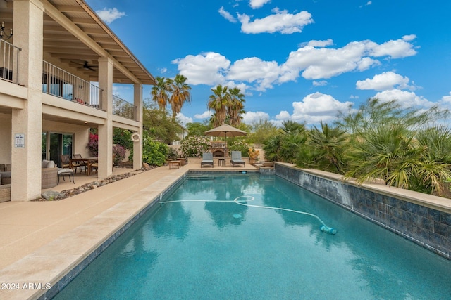 view of pool with ceiling fan and a patio