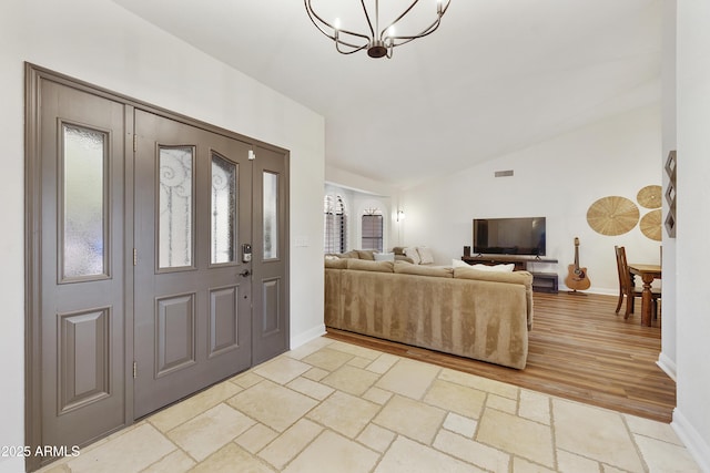 15857 E Ponderosa Dr, Fountain Hills, AZ 85268 - foyer entrance featuring lofted ceiling, a chandelier, baseboards, and light wood-type flooring