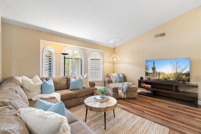 living room featuring hardwood / wood-style floors and vaulted ceiling