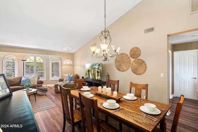 dining area with high vaulted ceiling, dark hardwood / wood-style flooring, and a notable chandelier