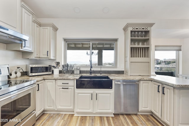 15857 E Ponderosa Dr, Fountain Hills, AZ 85268 - kitchen with appliances with stainless steel finishes, a sink, under cabinet range hood, light wood-type flooring, and light stone counters