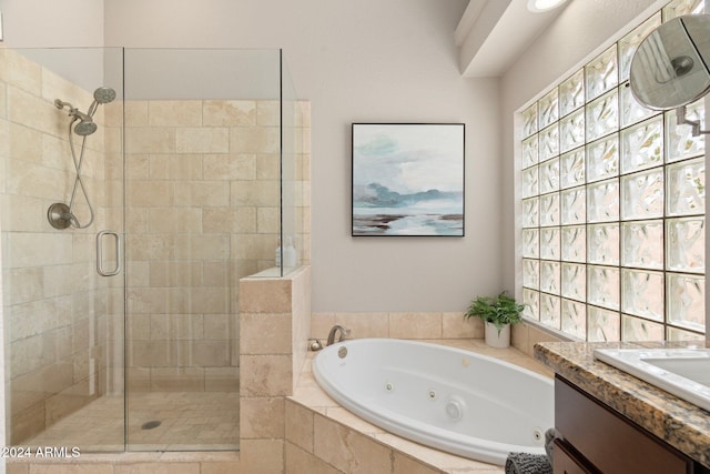 bathroom with vanity and separate shower and tub