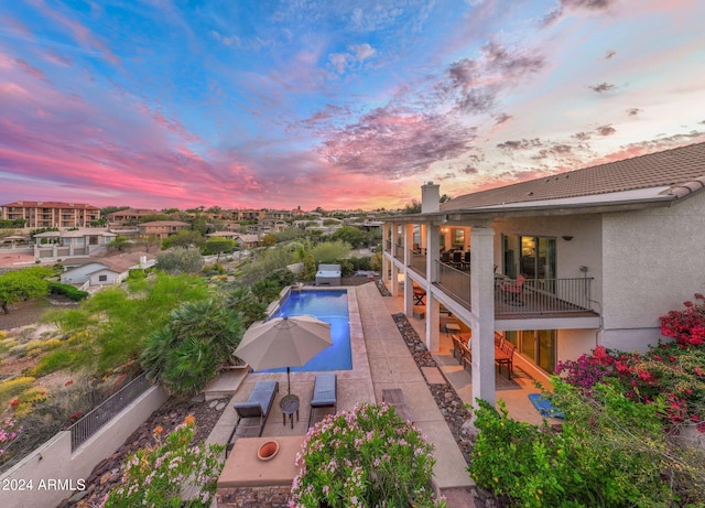 15857 E Ponderosa Dr, Fountain Hills, AZ 85268 - pool at dusk featuring a patio area and a fenced backyard