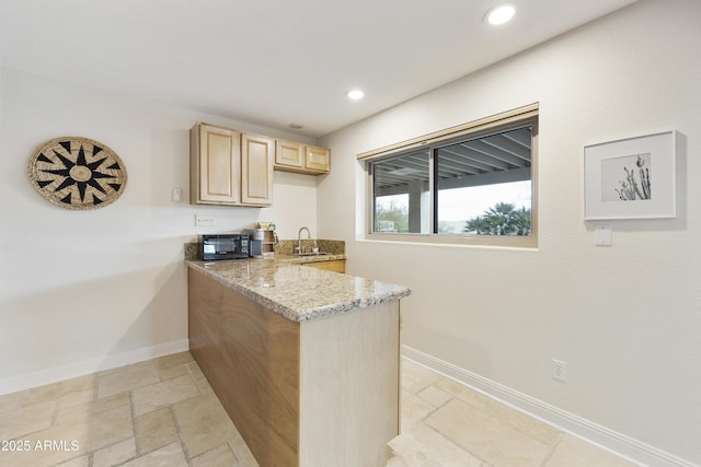 15857 E Ponderosa Dr, Fountain Hills, AZ 85268 - kitchen featuring light brown cabinets, a sink, stone tile floors, light stone countertops, and baseboards