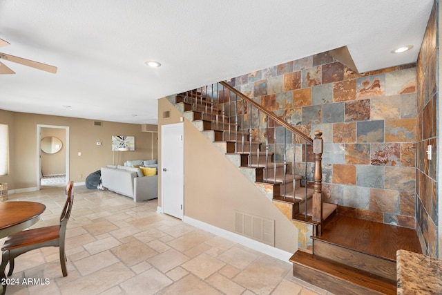 stairway with a textured ceiling