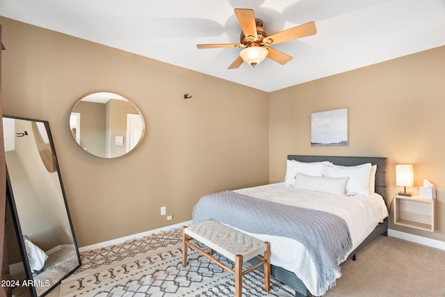 bedroom featuring light carpet and ceiling fan