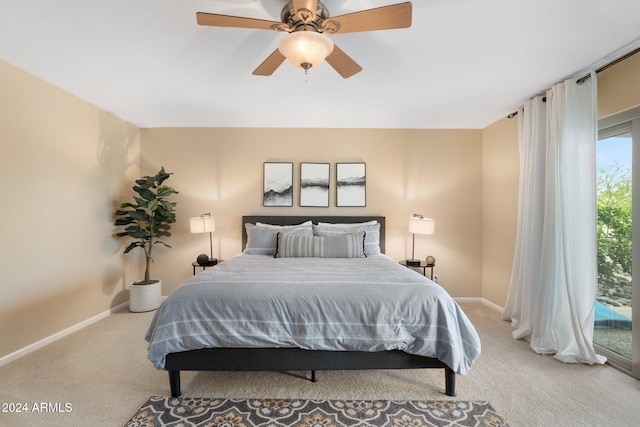 carpeted bedroom with multiple windows, ceiling fan, and access to exterior