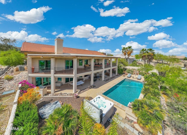 15857 E Ponderosa Dr, Fountain Hills, AZ 85268 - rear view of property featuring a balcony, a patio area, a chimney, and a hot tub