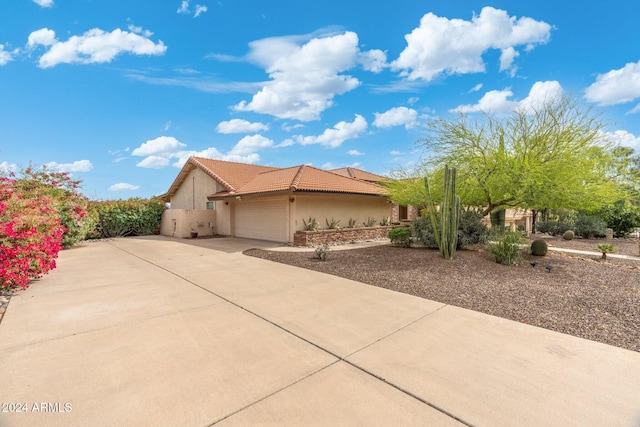 15857 E Ponderosa Dr, Fountain Hills, AZ 85268 - view of home's exterior with stucco siding, a garage, driveway, and a tiled roof