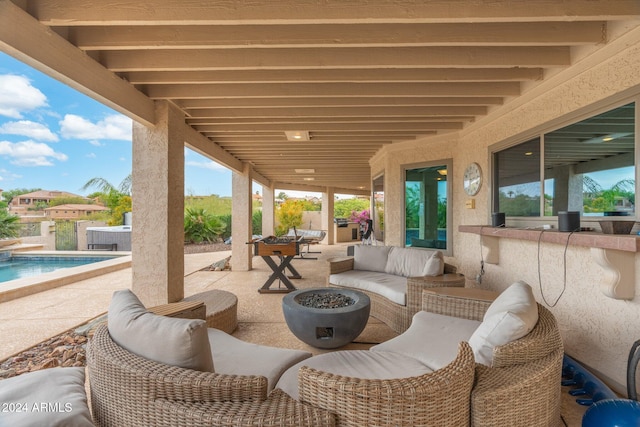 view of patio / terrace featuring an outdoor living space with a fire pit