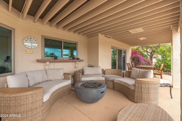 view of patio featuring an outdoor living space with a fire pit