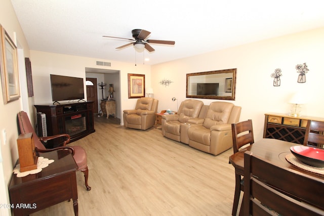 living room featuring ceiling fan and light hardwood / wood-style flooring