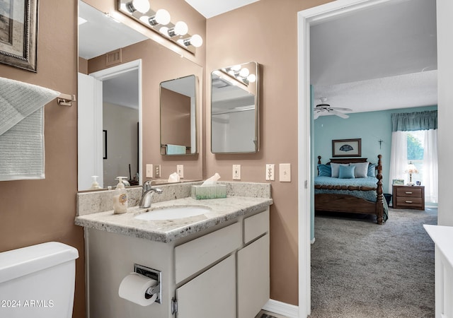 bathroom with vanity, ceiling fan, and toilet