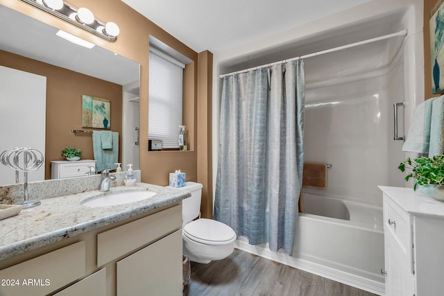 full bathroom with hardwood / wood-style flooring, vanity, toilet, and shower / tub combo with curtain