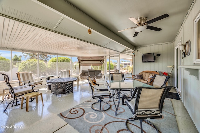 sunroom / solarium with a wealth of natural light and ceiling fan