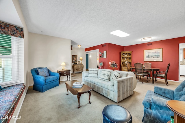 carpeted living room featuring a textured ceiling