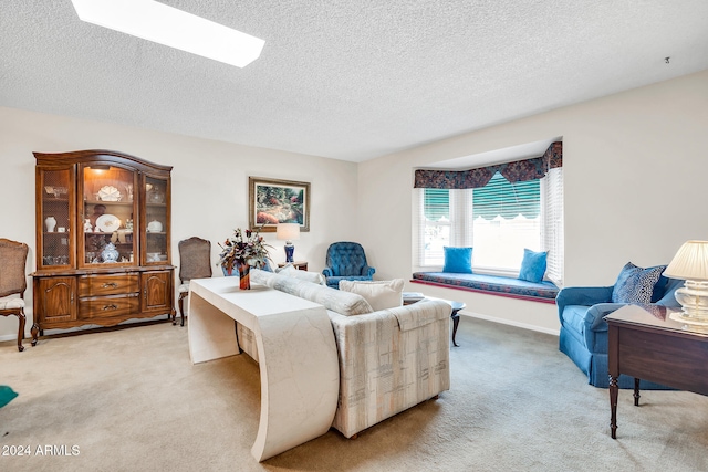 living room with a textured ceiling and light colored carpet