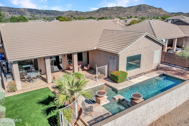 back of house with a patio area, a fenced in pool, and a mountain view